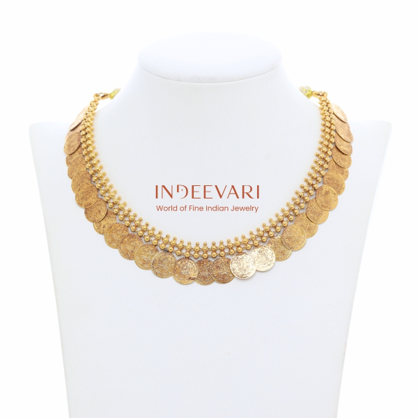 Graceful kasumala necklace with softly contoured gold coins arranged to follow natural neckline curve, featuring subtle mint-style surface detailing and warm antique gold finish