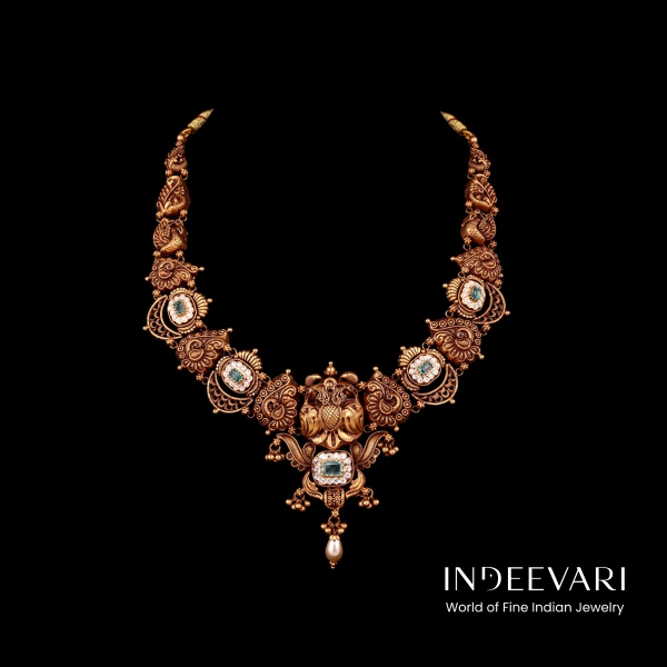 Majestic Mayur Nakshi Haar displaying intricately hand-carved peacock sculpture motifs arranged in graceful circular composition with detailed feather detailing, five luminous oval aquamarine gemstones set within ornate sunburst frames, grand central pend