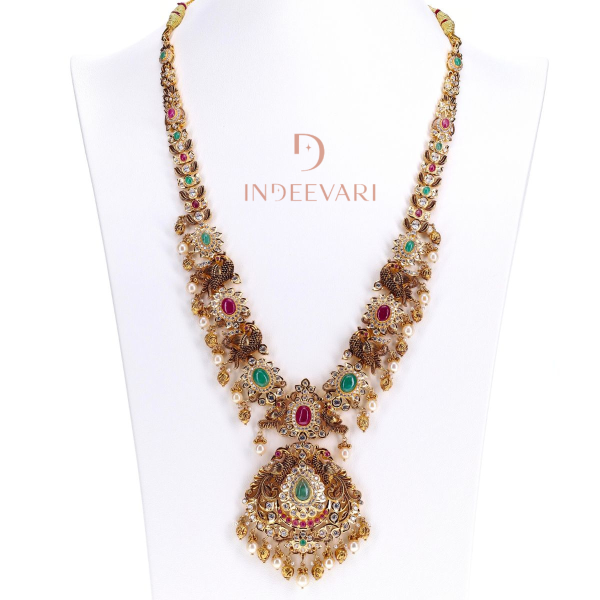Mayurika Elegant Pachiwork Necklace with cubic zirconia, rubies, emeralds, and pearls – handcrafted traditional Indian bridal jewelry in gold finish